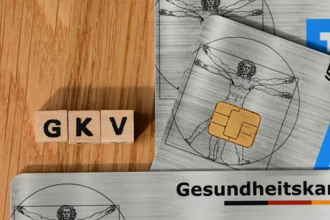 Zwei Gesundheitskarten und das Kürzel GKV als Symbol für Gesetzliche Krankenversicherung und Krankenkassen.