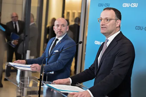 Jens Spahn und Alexander Hoffmann stehen an Rednerpulten vor Pressewand der CDU/CSU-Bundestagsfraktion und geben ein Statement vor der Fraktionssitzung ab