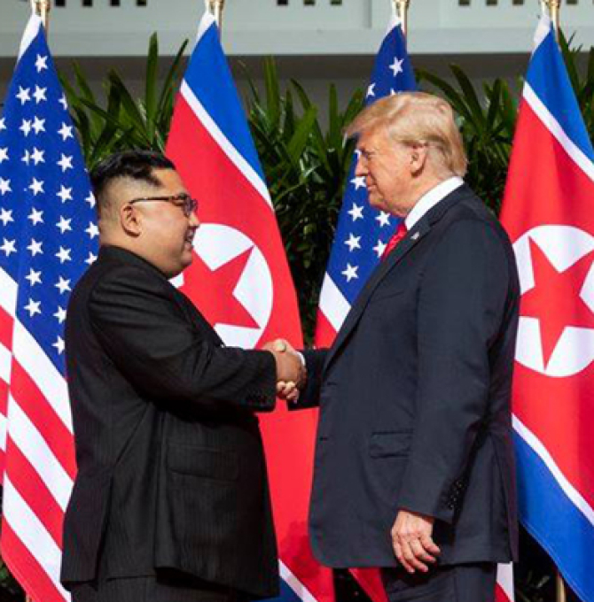U.S. President Donald Trump shakes hands with North Korean leader Kim Jong Un on June 12, 2018, at Singapore's Capella Hotel in what is the first meeting between a sitting U.S. president and a North Korean leader. White House Photo by Shealah Craighead/UPI Photo via Newscom picture alliance